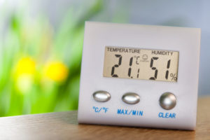 Hygrometer On A Table Shows Comfort Temperature And Humidity